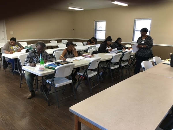 Adults taking a test for their continued education.
